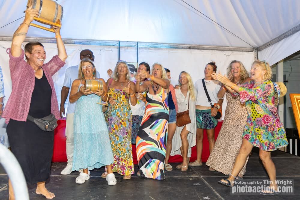 Cherub's all-female crew celebrating on stage with their regatta trophy