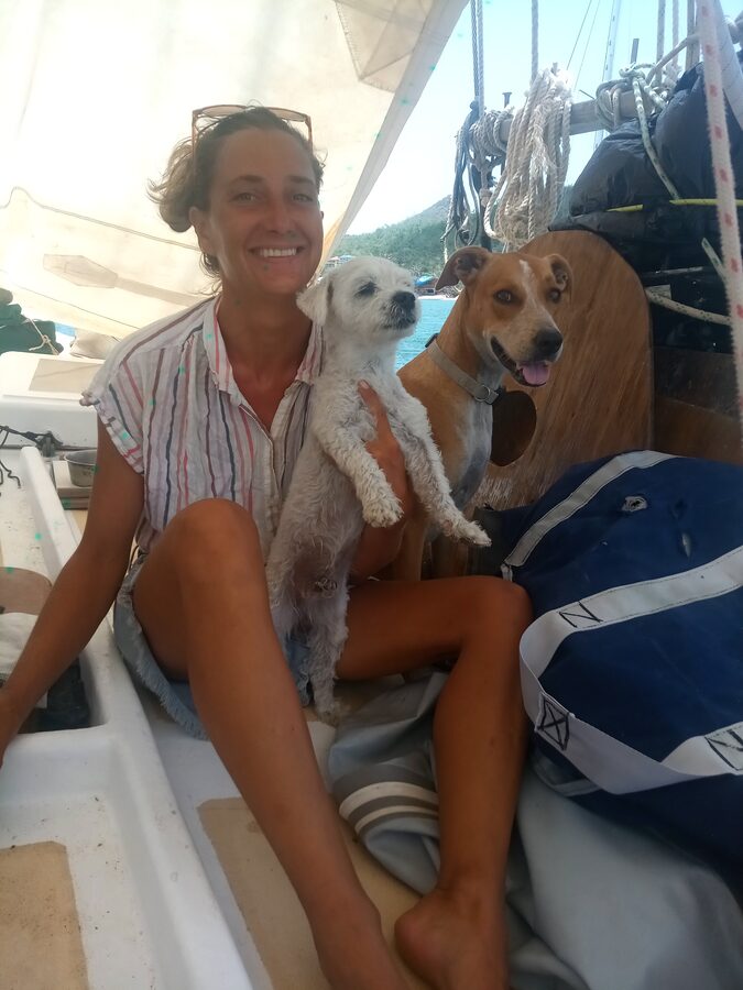 Angie aboard Cherub with two dogs